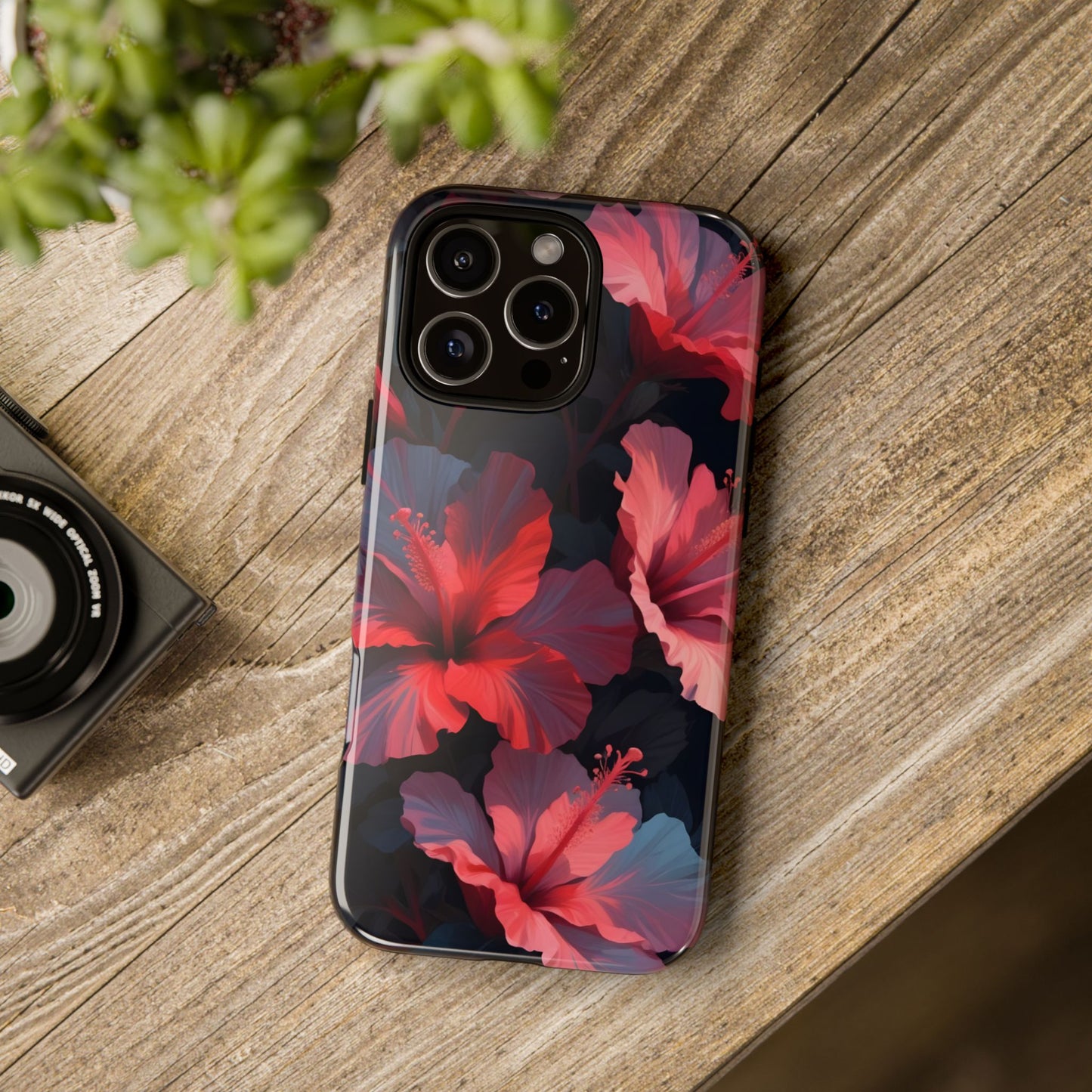 Vibrant red and pink hibiscus flowers blooming against a dark background| Floral phone case design