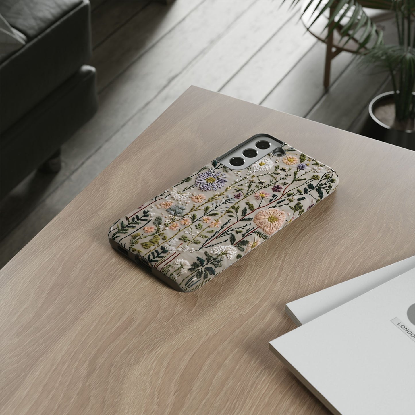 Intricate Embroidery Artwork Featuring Botanical Elements On Beige phone case design.