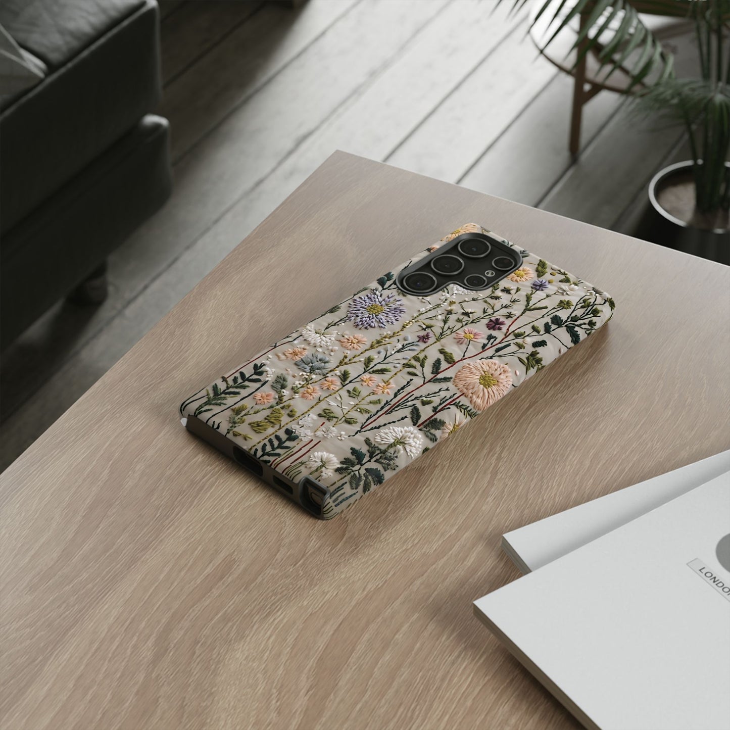 Intricate Embroidery Artwork Featuring Botanical Elements On Beige phone case design.