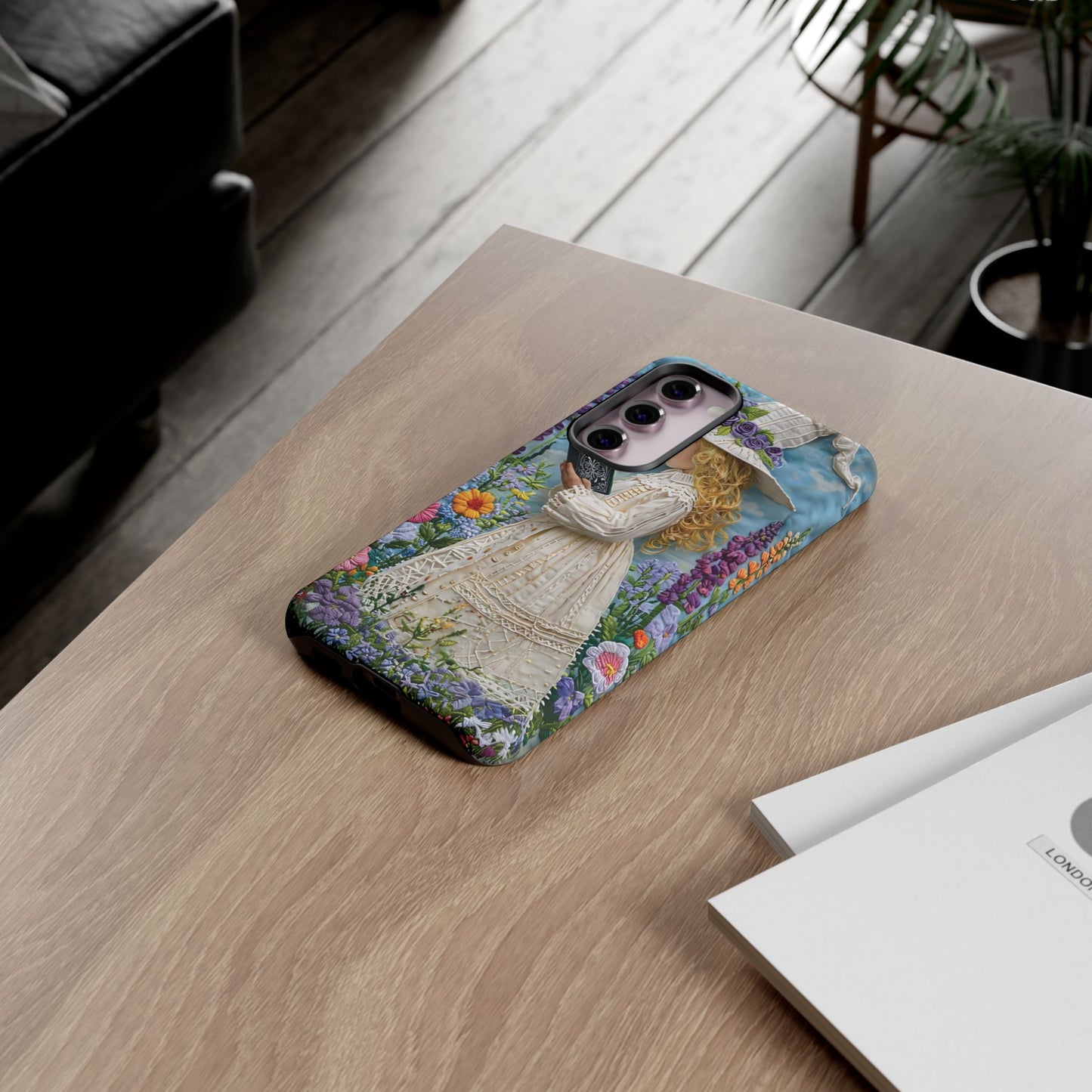 Whimsical Embroidery Of A Girl Reading In A Garden phone case design.