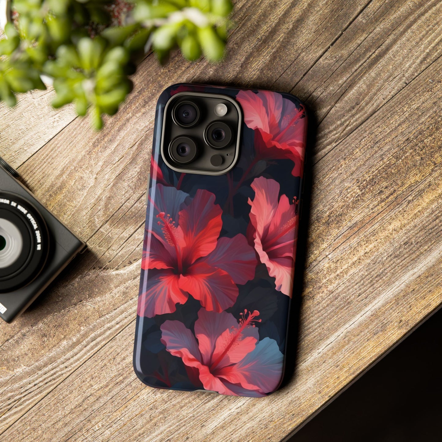 Vibrant red and pink hibiscus flowers blooming against a dark background| Floral phone case design