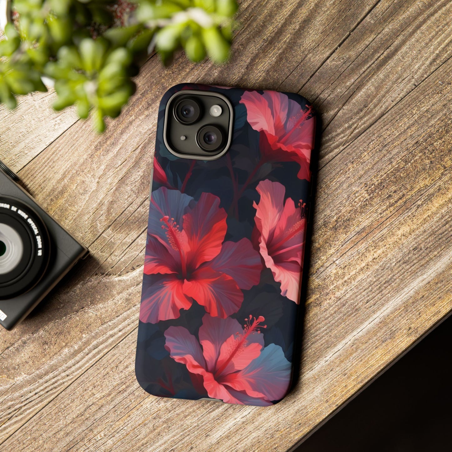 Vibrant red and pink hibiscus flowers blooming against a dark background| Floral phone case design