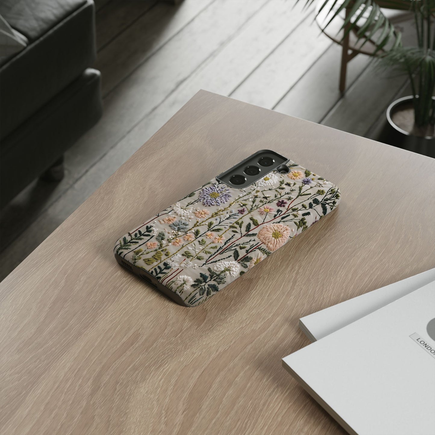 Intricate Embroidery Artwork Featuring Botanical Elements On Beige phone case design.