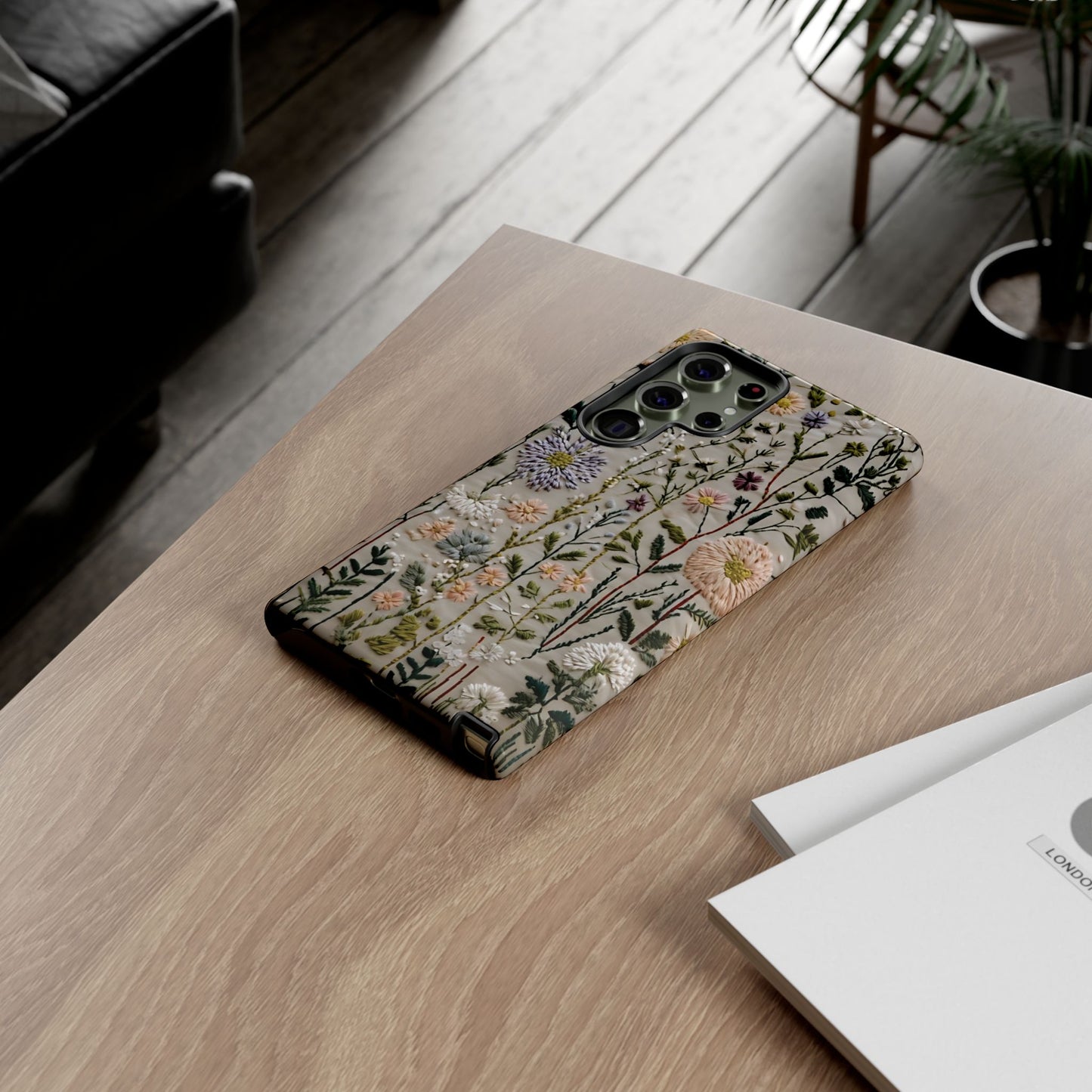 Intricate Embroidery Artwork Featuring Botanical Elements On Beige phone case design.