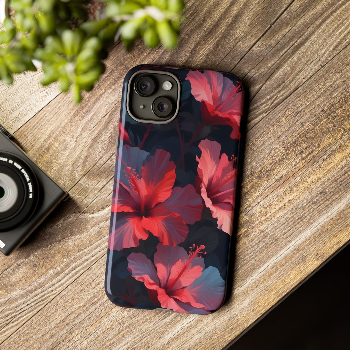 Vibrant red and pink hibiscus flowers blooming against a dark background| Floral phone case design