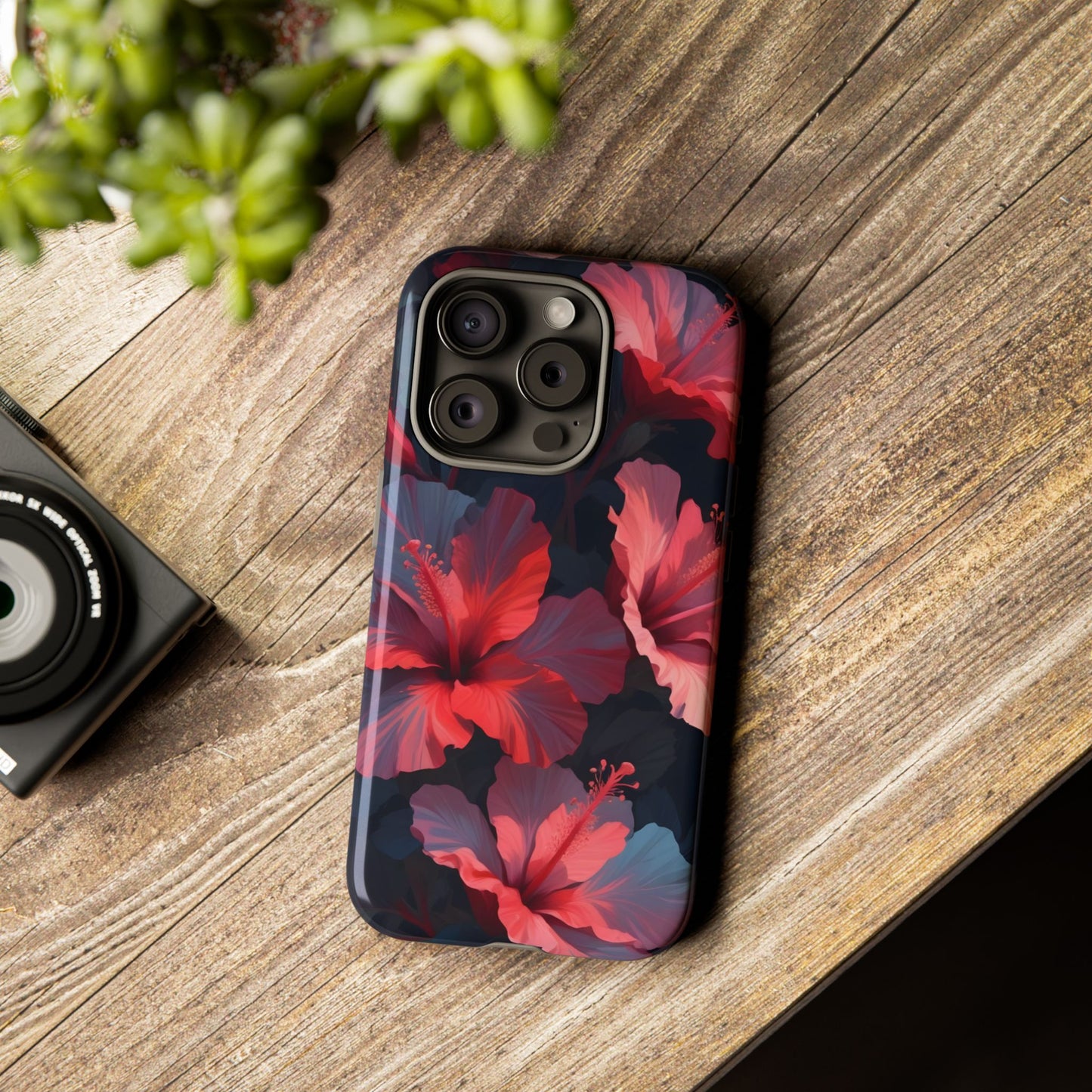 Vibrant red and pink hibiscus flowers blooming against a dark background| Floral phone case design