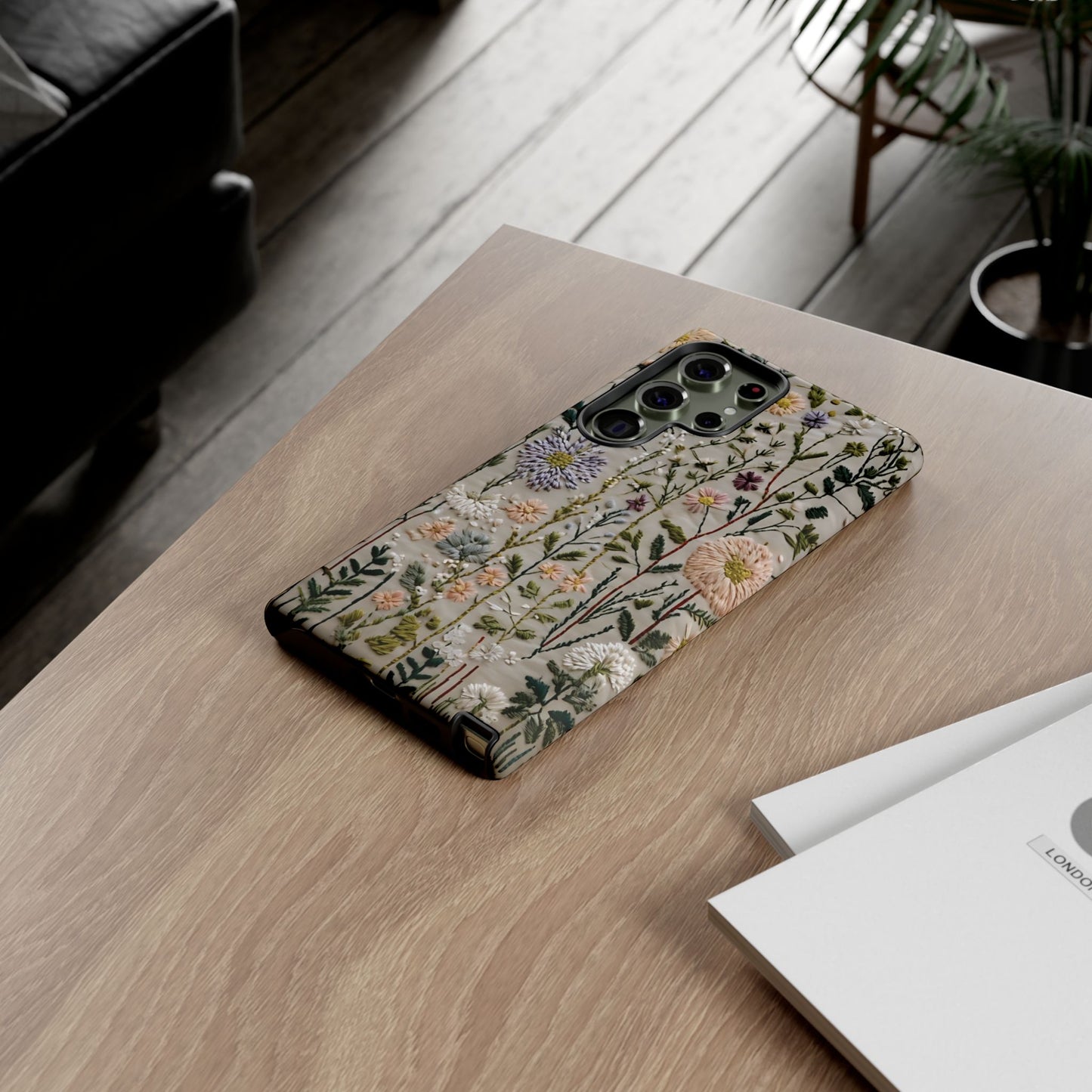 Intricate Embroidery Artwork Featuring Botanical Elements On Beige phone case design.