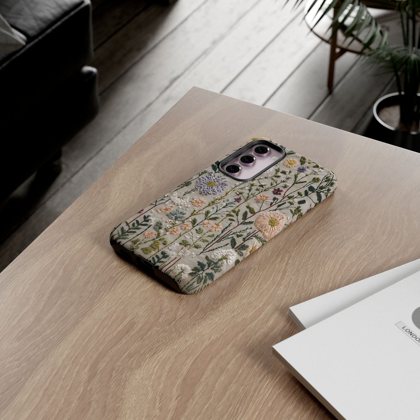 Intricate Embroidery Artwork Featuring Botanical Elements On Beige phone case design.