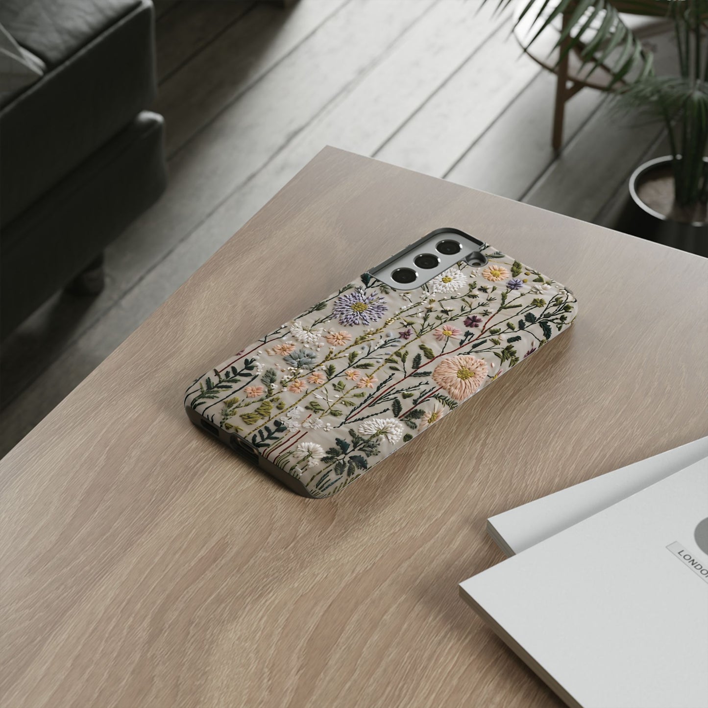 Intricate Embroidery Artwork Featuring Botanical Elements On Beige phone case design.