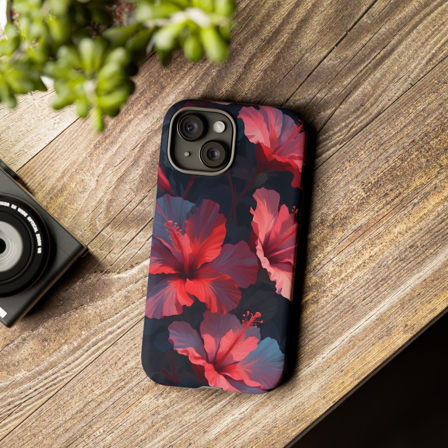 Vibrant red and pink hibiscus flowers blooming against a dark background| Floral phone case design