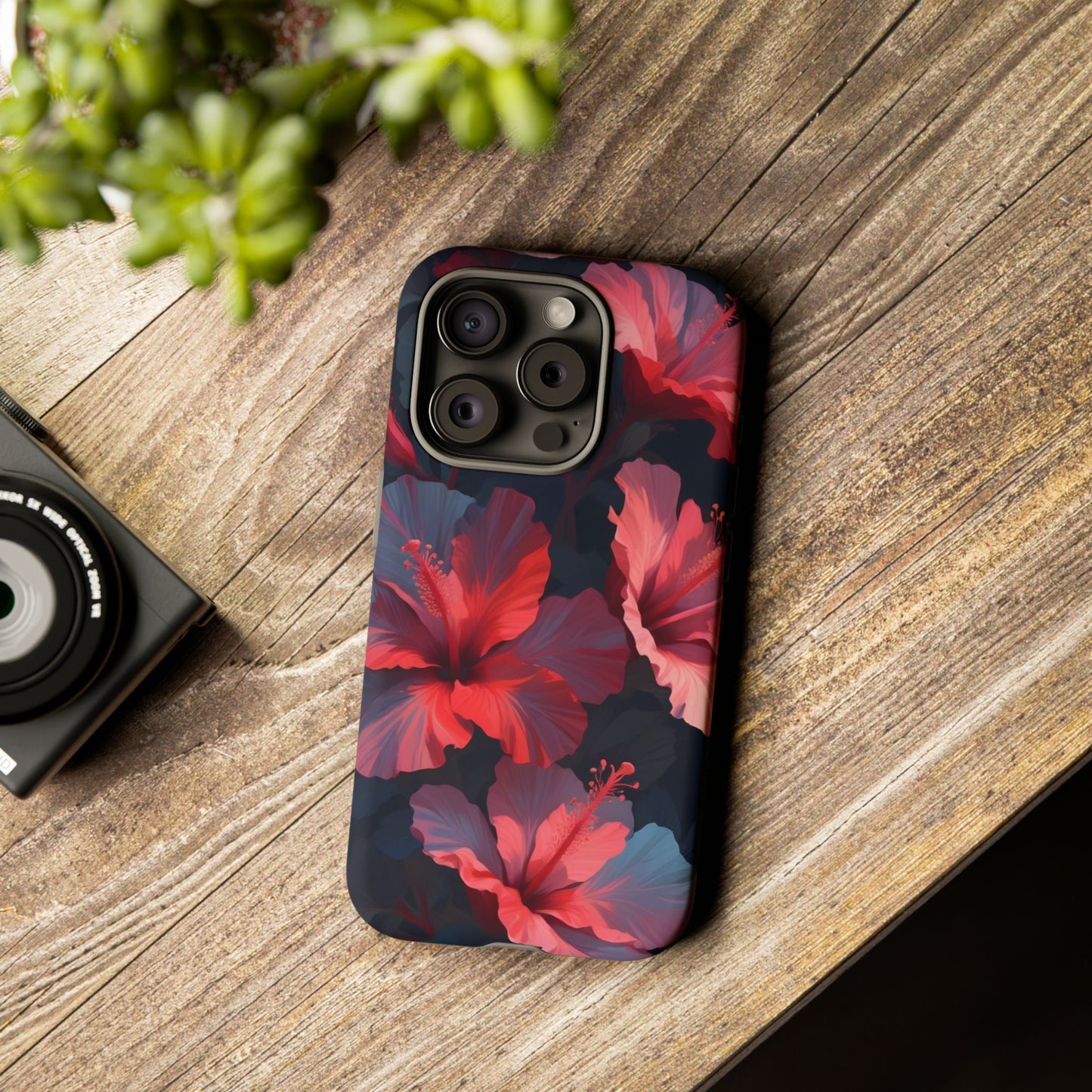 Vibrant red and pink hibiscus flowers blooming against a dark background| Floral phone case design