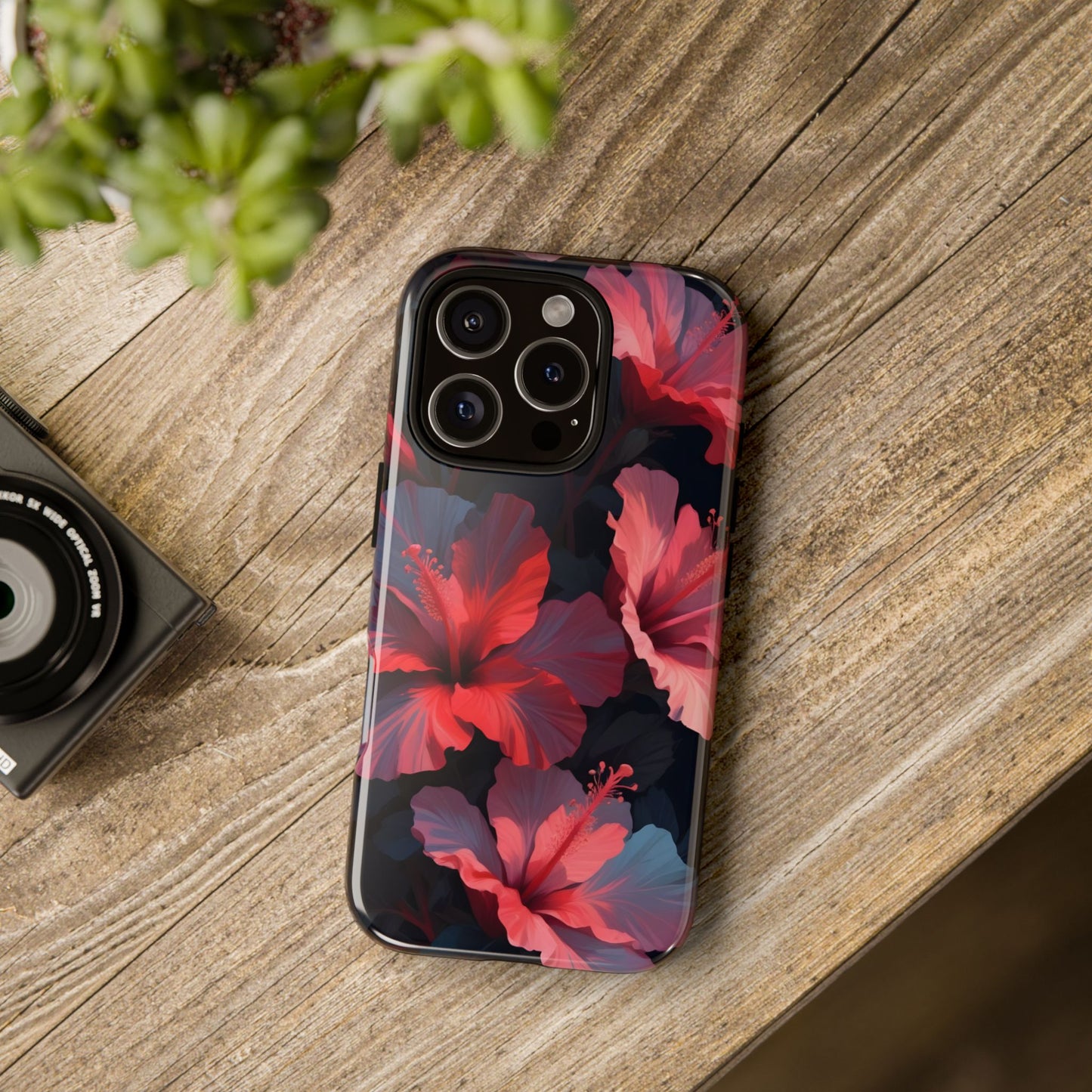 Vibrant red and pink hibiscus flowers blooming against a dark background| Floral phone case design