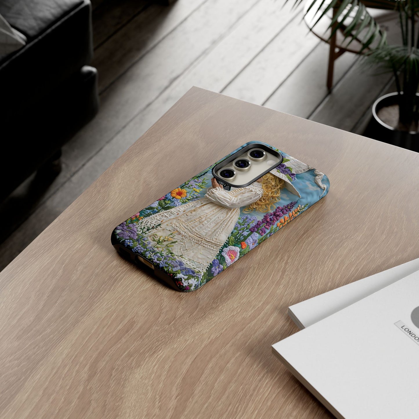 Whimsical Embroidery Of A Girl Reading In A Garden phone case design.